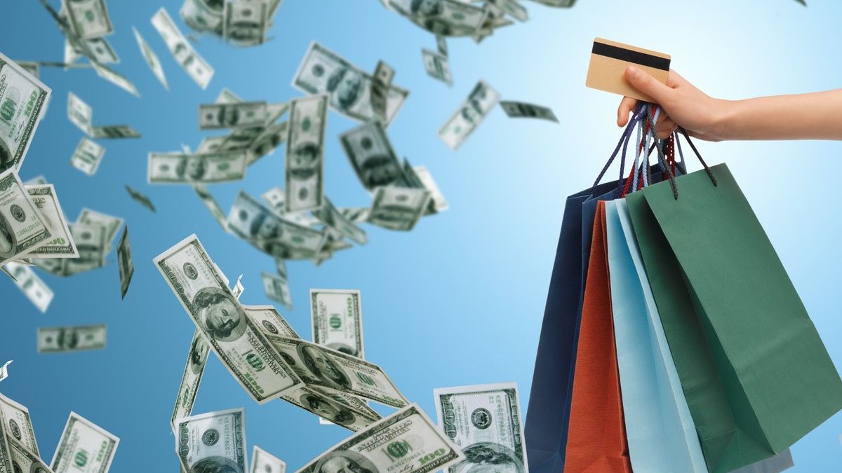 The picture depicts a money flying around excessively in the air and shopping bags 
